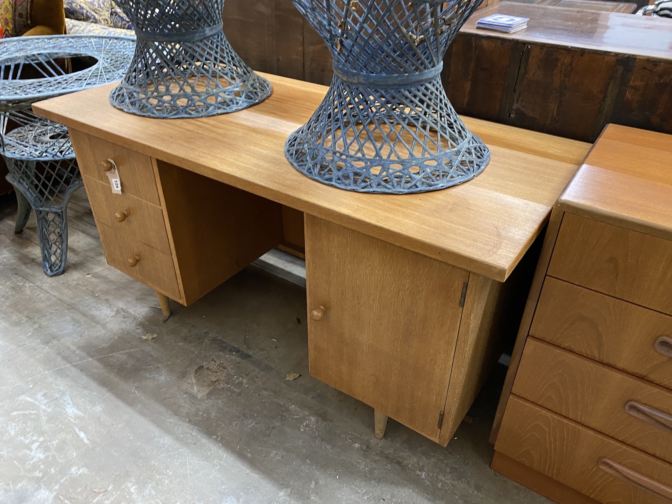 A mid century oak kneehole desk by Neredew, width 132cm, depth 60cm, height 70cm